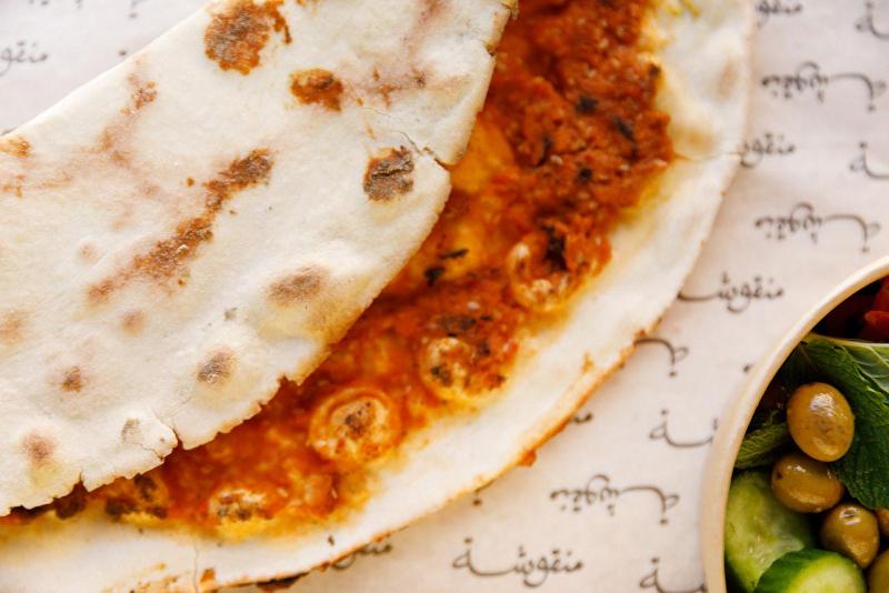 Manousheh: Kishek, 1 x $11.00
dried yogurt with tomato, onion, and sesame seeds baked on our flatbread