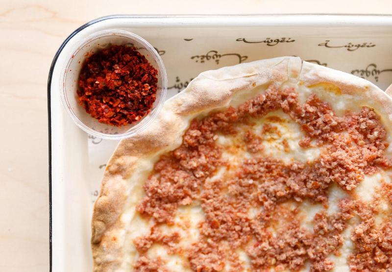 Manousheh: Lahem bi ajine - TP , 1 x $7.00
ground beef, tomatoes, and onion baked on our crispy flatbread
