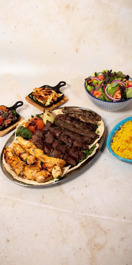 SALMA EAST VILLAGE: Family Mixed Grill Platter, 1 x $118.00
Beef, Poultry. Serves 6 people. This family platter includes 2 kafta skewers, 2 chicken kebab skewers, 2 filet mignon skewers, 2 lamb chops, shawarma lamb or chicken, fattouch, and rice