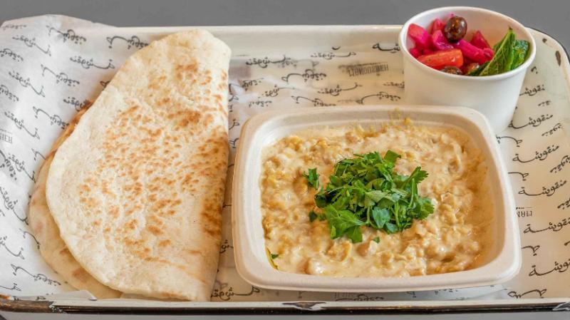 Manousheh: Msabaha - TP , 1 x $13.00
boiled chickpeas mixed with garlic, lemon juice, and tahini, then topped with olive oil and chopped parsley