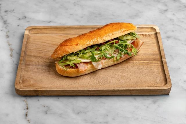 Aux Merveilleux de Fred - Midtown: Prosciutto Brioche Sandwich, 1 x $8.80
Our signature Brioche bun filled with Italian Prosciutto, and complemented with Provolone cheese, Arugula and sun dried tomatoes blended with Olive oil. A moist, soft and balanced sandwich where bread is a star!