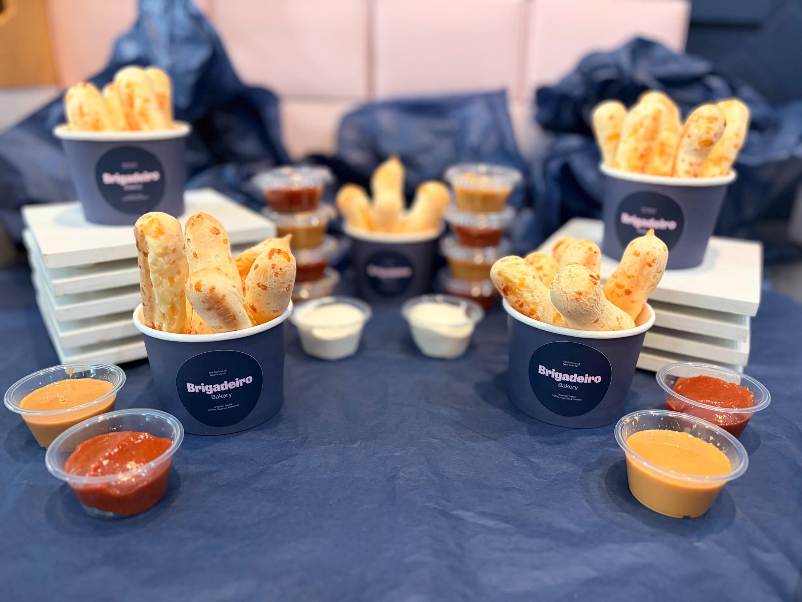 Brigadeiro Bakery: Pão Snack Cup , 1 x $7.50
Introducing our Pão Snack Cup—a deliciously snackable twist on a Brazilian favorite! We serve golden, cheesy pão de queijo sticks paired with your choice of dip—whether it’s creamy requeijão, indulgent dulce de leche, or fruity guava. Even better? The sticks are gluten-free, made with the same beloved recipe as our traditional pão de queijo. Enjoy it solo or share with a friend. And if you can’t get enough, feel free to add extra dips for even more flavor!