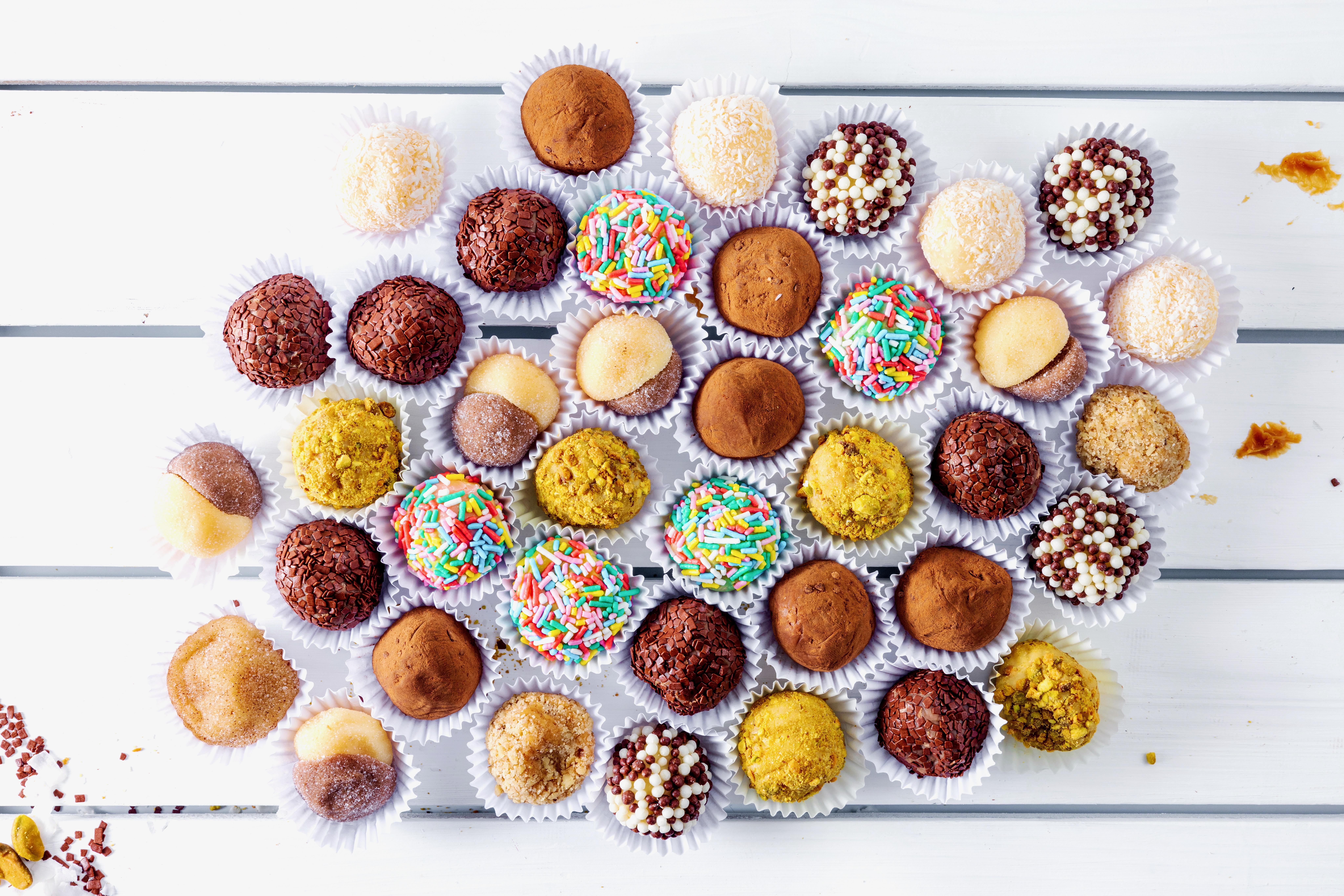 Brigadeiro Bakery: Best Sellers Brigadeiro Box, 1 x $124.00
Brigadeiro is a delicious and popular Brazilian sweet treat, often referred to as a type of bonbon or truffle. It is one of the most beloved desserts in Brazil and is commonly served at parties, celebrations, and gatherings. The brigadeiro's simplicity and rich flavor make it a favorite among people of all ages.
Our Best Sellers Brigadeiros (soft truffles):

Classic Chocolate – Rich chocolate is blended into sweetened condensed milk
to form this classic brigadeiro flavor. It is then rolled in chocolate sprinkles as
they traditionally do in Brazil.

Ingredients: Sweetened condensed milk, Nescau (chocolate powder), butter,
chocolate sprinkles, canola oil spray.

White Crunch – This sweet, gooey treat is rolled in chocolate crispies that add
the perfect crunch to its creamy interior.

Ingredients: sweetened condensed milk, butter, power ball, corn scratch, canola oil spray, crunch sprinkles.

Coconut – Coconut, which grows in abundance in Brazil, is the highlight of this
brigadeiro. Fresh coconut is infused with the creamy condensed milk ball and
then it is rolled in shredded coconut to make this classic flavor.

Ingredients: sweetened condensed milk, coconut (dried), butter, corn scratch,
canola oil spray

Two lovers – This brigadeiro features two classic flavors intertwined as one.
Rolled together in sugar, one side features the classic creamy condensed milk
flavor and the other is the creamy chocolate.

Ingredients: sweetened condensed milk, butter, power ball, corn scratch, coconut, Nescau (chocolate powder),