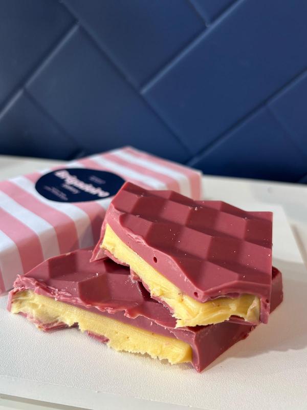 Brigadeiro Bakery: Ruby Chocolate Bar with Passion Fruit Cream – Limited Edition, 1 x $18.00
Ruby Chocolate Bar with Passion Fruit Cream – Limited Edition 

 A bold twist on chocolate, made to delight and surprise! 
Crafted with naturally pink ruby chocolate, this limited edition bar is filled with a tasty passion fruit cream, 
creating a vibrant balance of sweet, tart, and tropical flavors. 
With its striking color and unique taste, it’s a perfect gift—or a luxurious treat for yourself.
Flavor Profile:
Fruity and slightly tart ruby chocolate;
Tropical passion fruit cream center;
Smooth, creamy finish with a refreshing brightness. 

Perfect for Mother's Day, gifting, or anyone who loves discovering new chocolate experiences.

Storage: Keep in a cool, dry place away from direct sunlight. Best enjoyed at room temperature.

Available online and at the store – limited quantities!