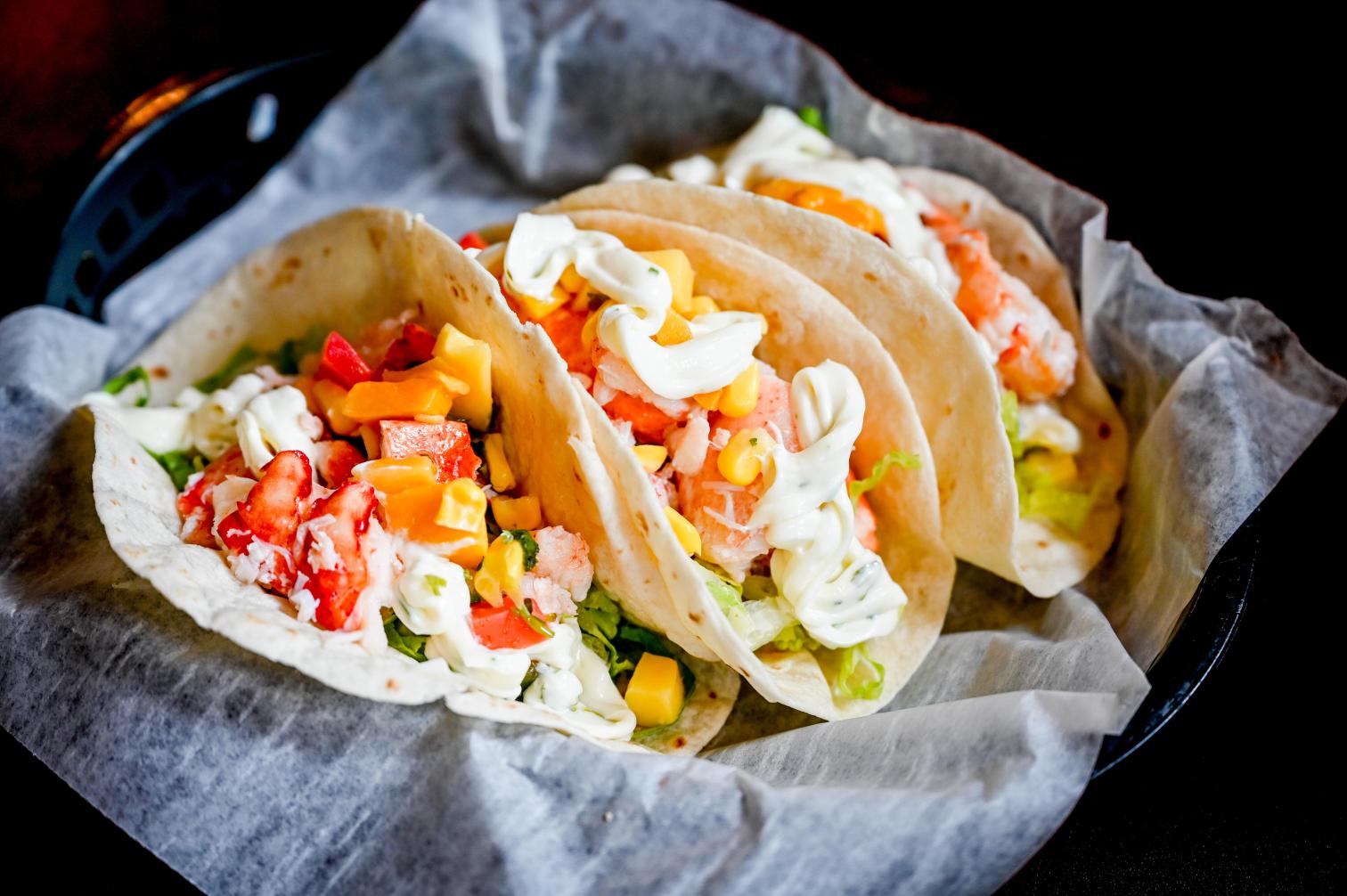 Lobstah On A Roll: New England Tacos, 1 x $22.50
Indulge in the authentic flavors of New England with our mouth-watering soft tacos stuffed with Lobstah, lettuce, roast corn, and mango salsa, all drizzled with cilantro aioli. Experience a unique culinary adventure with every bite - order your New England Tacos now!