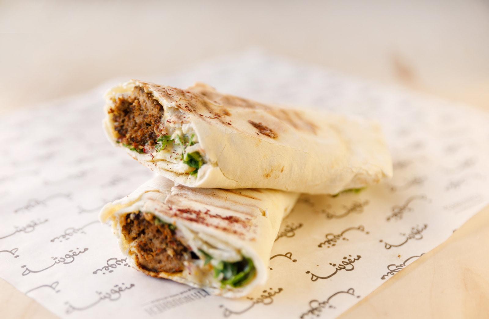 Manousheh: Kafta, 2 x $13.00
ground lamb and beef served with hummus, onion, and parsley sumac mix on our freshly baked flatbread