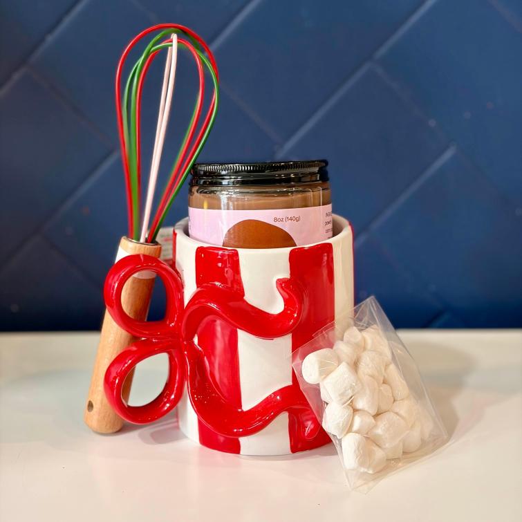 Brigadeiro Bakery: Brigadeiro Hot Chocolate Gift Set, 1 x $36.00
Brigadeiro Hot Chocolate Kit - Holiday Special
Bring the beloved Brazilian treat to your cozy winter evenings with our limited-edition Brigadeiro Hot Chocolate Kit. This thoughtfully curated set transforms our signature chocolate brigadeiro into the most indulgent hot chocolate you've ever tasted.

What's Inside
Each kit includes everything you need for the ultimate hot chocolate experience:
Festive Ceramic Mug - A beautifully designed holiday mug that keeps your drink warm and brings seasonal cheer to every sip
8oz Jar of Chocolate Brigadeiro - Our rich, velvety brigadeiro made with premium cocoa and sweetened condensed milk, ready to melt into pure liquid comfort
Artisan Whisk - A charming mini whisk for creating that perfect frothy texture
2oz Mini Marshmallows - Fluffy, pillowy marshmallows to crown your creation
The Brigadeiro Difference
Unlike ordinary hot chocolate mixes, our brigadeiro base delivers an authentically Brazilian experience with its signature creamy texture and deep chocolate flavor. Each spoonful melts into hot milk to create a luxuriously thick, almost pudding-like hot chocolate that feels like a warm hug in a mug.

Perfect For
Holiday gifting for chocolate lovers
Cozy night-in essentials
Secret Santa exchanges
Treating yourself to something special
Creating new holiday traditions